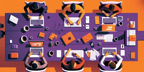 A meeting table seen from above, with several macbooks, papers, monitors on the table, with people working on them